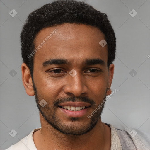 Joyful black young-adult male with short  black hair and brown eyes