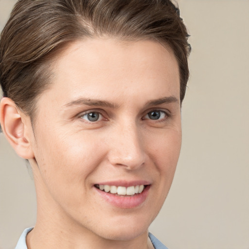 Joyful white young-adult female with short  brown hair and grey eyes