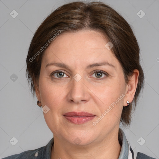 Joyful white adult female with medium  brown hair and grey eyes