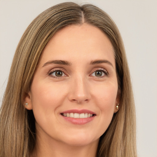 Joyful white young-adult female with long  brown hair and brown eyes