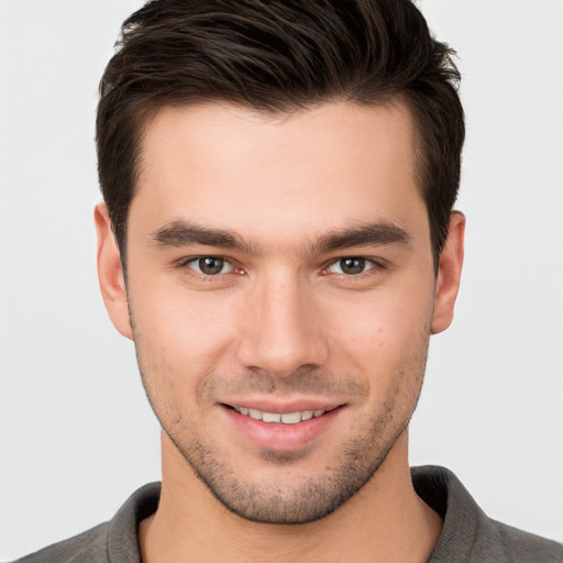 Joyful white young-adult male with short  brown hair and brown eyes