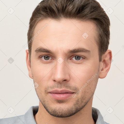 Neutral white young-adult male with short  brown hair and grey eyes