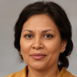 Joyful white adult female with medium  brown hair and brown eyes