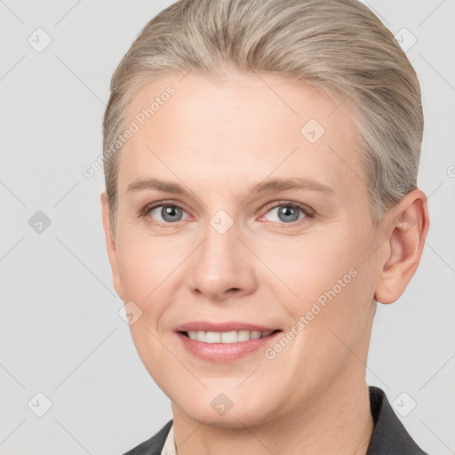 Joyful white young-adult female with short  brown hair and grey eyes