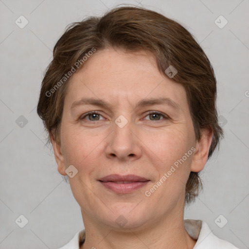 Joyful white adult female with medium  brown hair and grey eyes