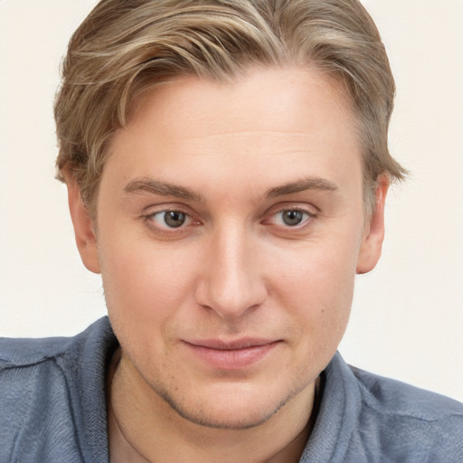 Joyful white young-adult male with short  brown hair and blue eyes