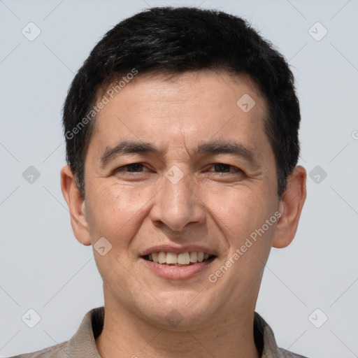 Joyful white adult male with short  brown hair and brown eyes