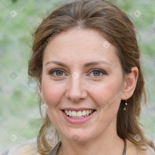 Joyful white adult female with medium  brown hair and grey eyes