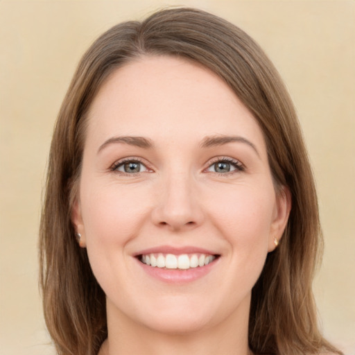 Joyful white young-adult female with medium  brown hair and green eyes