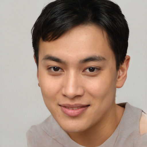 Joyful asian young-adult male with short  brown hair and brown eyes