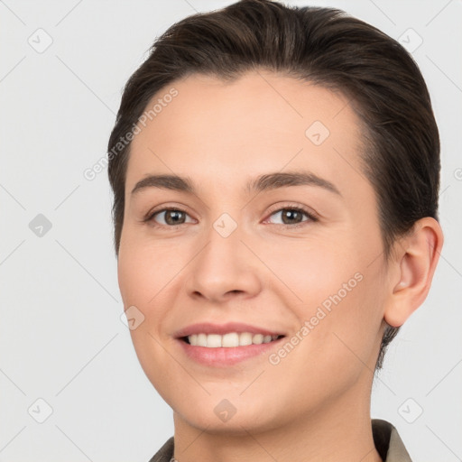 Joyful white young-adult female with short  brown hair and brown eyes