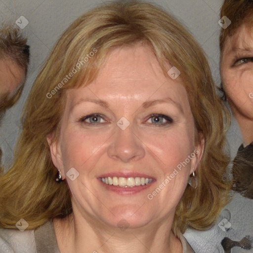 Joyful white adult female with medium  brown hair and blue eyes