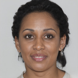 Joyful black adult female with short  brown hair and brown eyes