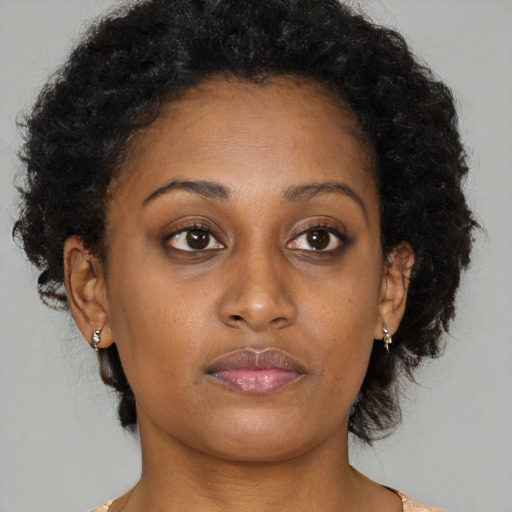 Neutral black young-adult female with medium  brown hair and brown eyes
