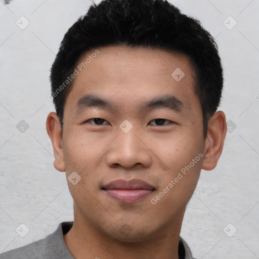 Joyful asian young-adult male with short  black hair and brown eyes