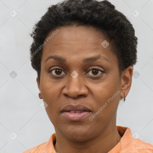 Joyful black adult female with short  brown hair and brown eyes