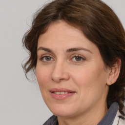 Joyful white adult female with medium  brown hair and grey eyes