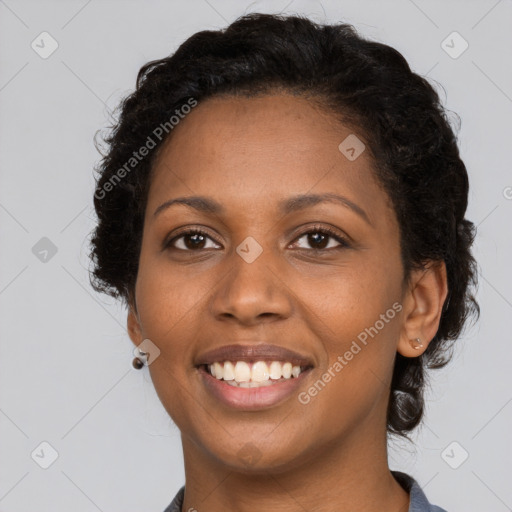 Joyful black young-adult female with long  brown hair and brown eyes