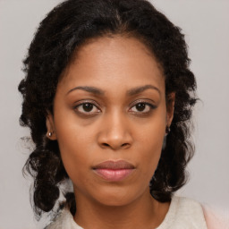 Neutral black young-adult female with medium  brown hair and brown eyes