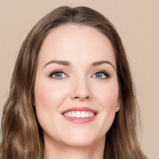 Joyful white young-adult female with long  brown hair and green eyes