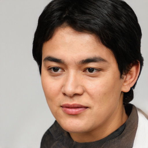 Joyful white young-adult male with medium  black hair and brown eyes