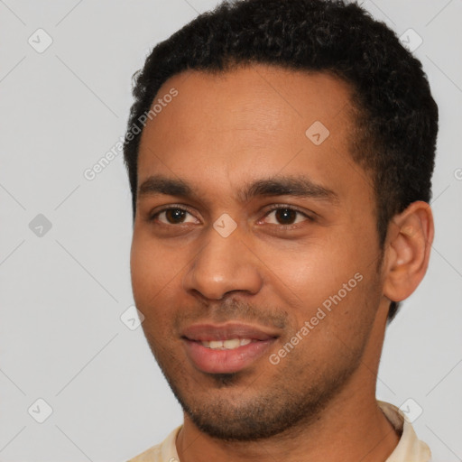 Joyful latino young-adult male with short  black hair and brown eyes