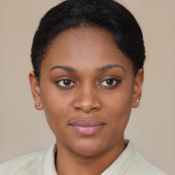 Joyful black young-adult female with short  brown hair and brown eyes