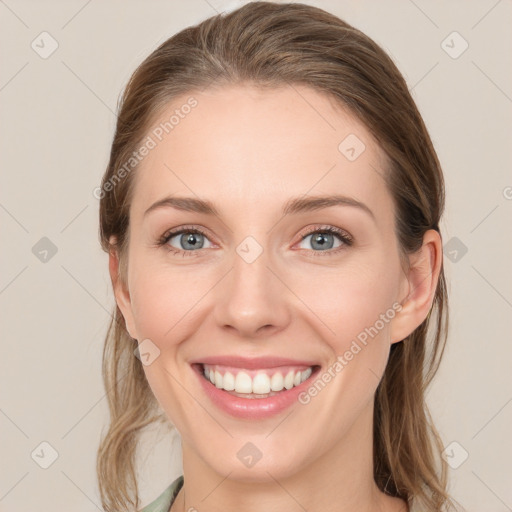 Joyful white young-adult female with long  brown hair and blue eyes