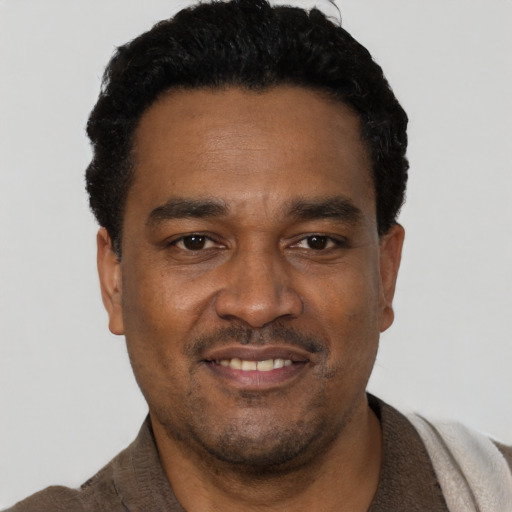 Joyful latino adult male with short  black hair and brown eyes