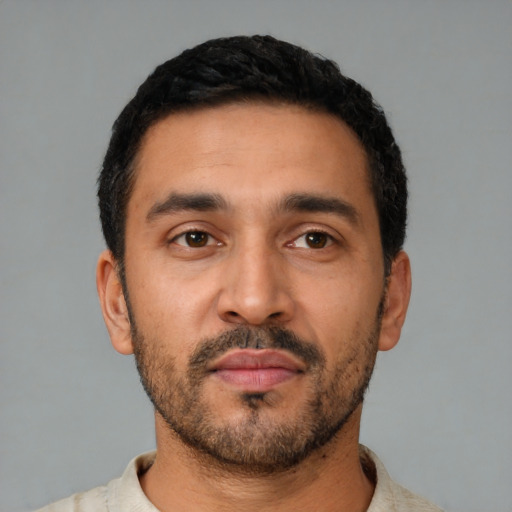 Neutral latino young-adult male with short  black hair and brown eyes