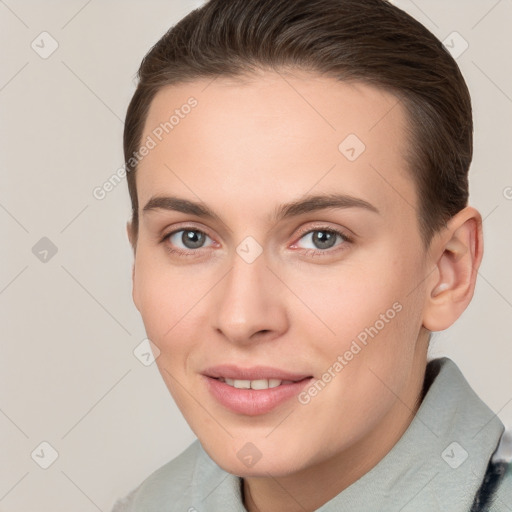 Joyful white young-adult female with short  brown hair and brown eyes