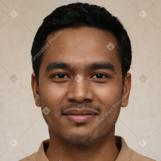 Joyful black young-adult male with short  black hair and brown eyes