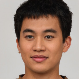 Joyful asian young-adult male with short  brown hair and brown eyes