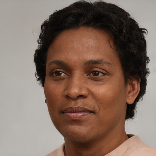 Joyful black adult female with short  brown hair and brown eyes