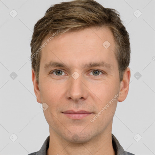 Joyful white adult male with short  brown hair and grey eyes