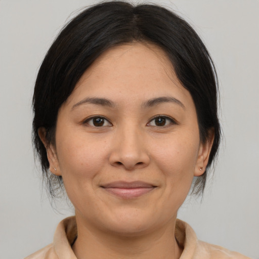 Joyful asian young-adult female with medium  brown hair and brown eyes