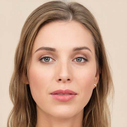 Joyful white young-adult female with long  brown hair and green eyes