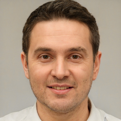 Joyful white adult male with short  brown hair and brown eyes