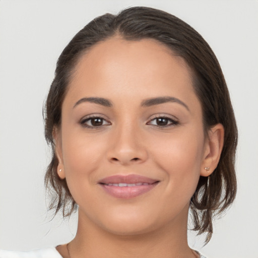 Joyful latino young-adult female with medium  brown hair and brown eyes