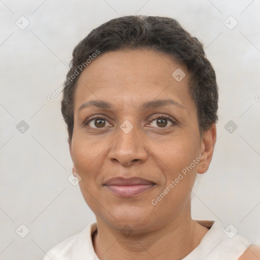 Joyful latino adult female with short  brown hair and brown eyes