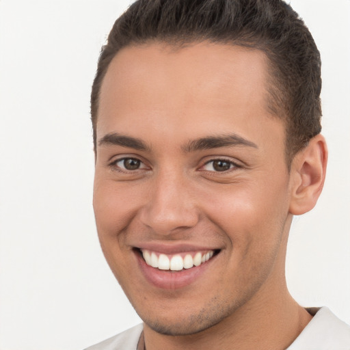 Joyful white young-adult male with short  brown hair and brown eyes