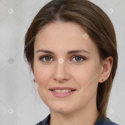 Joyful white young-adult female with medium  brown hair and grey eyes