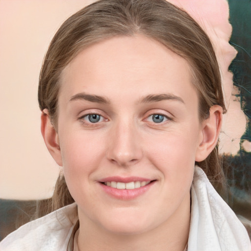 Joyful white young-adult female with medium  brown hair and blue eyes