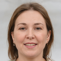 Joyful white adult female with medium  brown hair and brown eyes