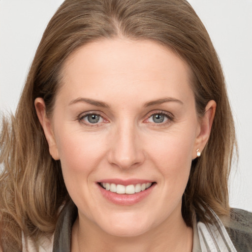 Joyful white young-adult female with long  brown hair and grey eyes