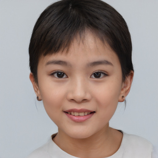 Joyful asian child female with short  brown hair and brown eyes
