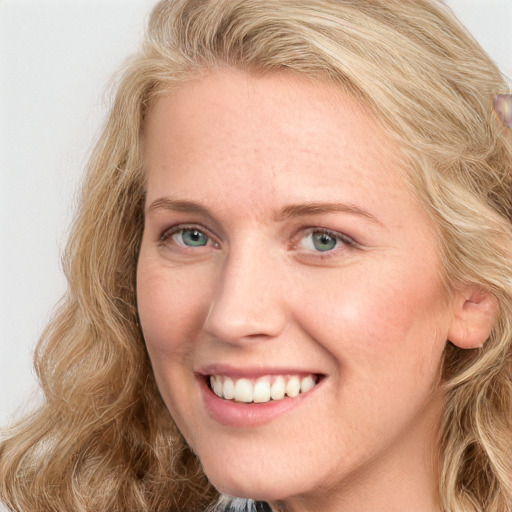 Joyful white young-adult female with long  brown hair and blue eyes