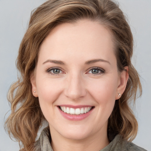 Joyful white young-adult female with medium  brown hair and blue eyes