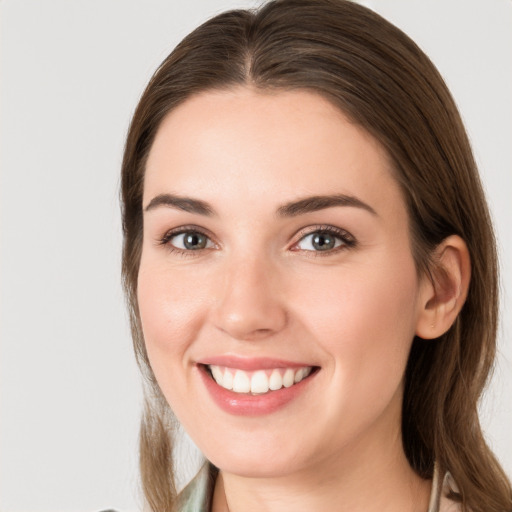 Joyful white young-adult female with long  brown hair and grey eyes