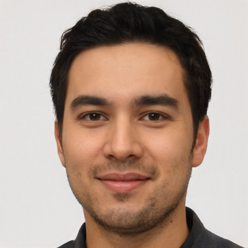 Joyful latino young-adult male with short  black hair and brown eyes
